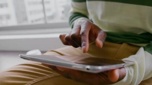 Hand Using Tablet in Modern Home