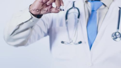 Doctor Writes Smoking Kills on Glass Surface