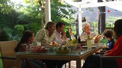Family eating outside together in summer