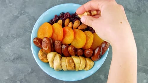 Dried cranberries apricots figs dates nuts bowl Healthy dry fruit berry snack breakfast nutritious