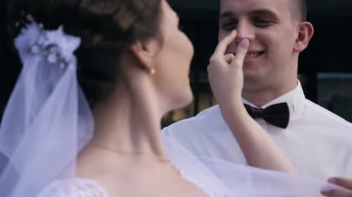 Bride Touches Groom's Face on Wedding Day