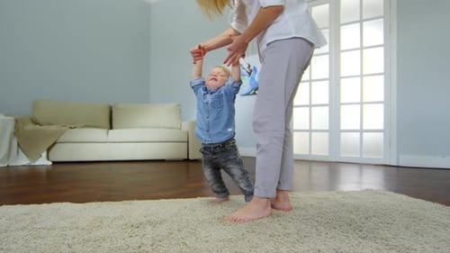 Baby Learning to Walk With a Loving Parent