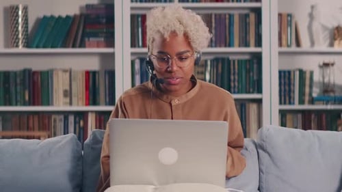 Young Woman Video Calling on Laptop at Home