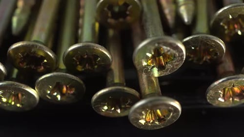 Macro Footage of Shiny Gold Screws Close Up