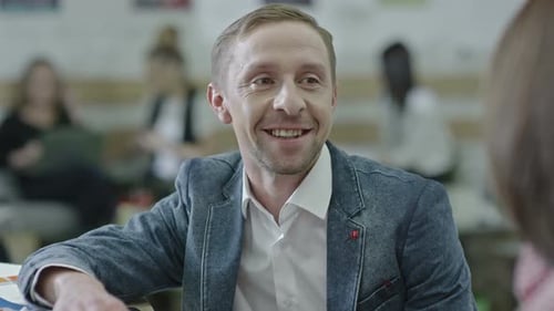 Smiling Businessman Chatting in Modern Office Space