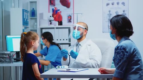 Doctor Examines Child Patient in a Clinic Office