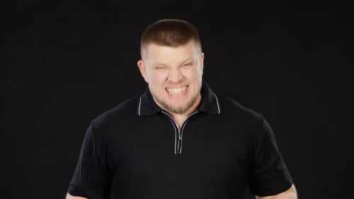 Angry Man Clenches Fists and Makes Faces
