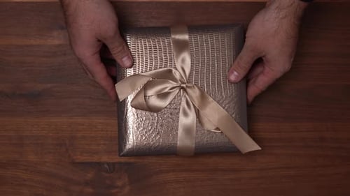 Wrapped Gift Presented on Wooden Table Top