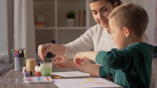 Mother and Son Painting Pictures Together at Home