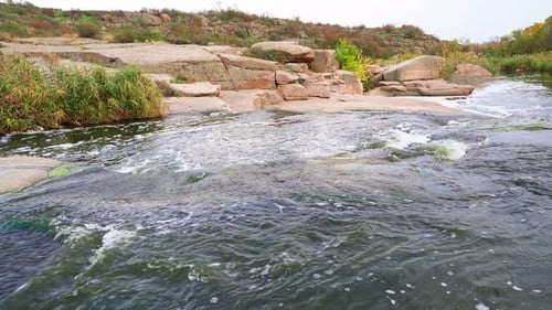 A Small Shining Stream Flows Among Smooth Wet and Dark Stones