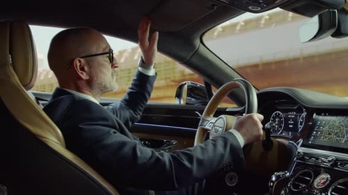 Man Drives Luxury Car Through City Streets