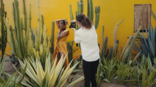Woman Posing for Photographer Among Cacti