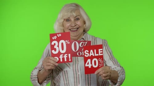 Senior Woman Presenting Sale Discount Signs