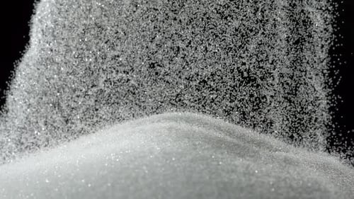 Pile of sugar on black background, Slow Motion