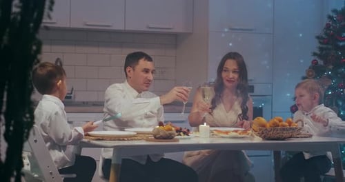 Family Celebrates Christmas with Toast at Home