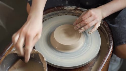 Potter Shaping Clay on a Pottery Wheel