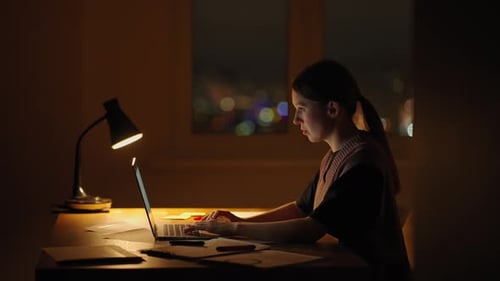 Young Good Looking Caucasian Woman Typing and Working on the Laptop Computer As Freelancer While