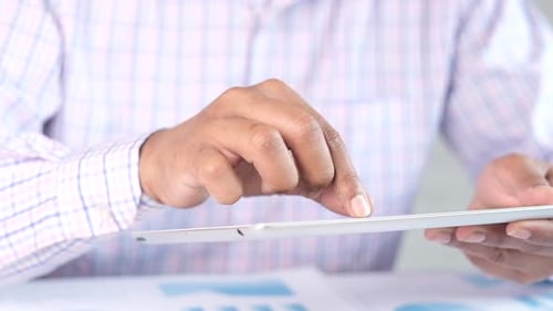 Businessman Using Digital Tablet on Office Desk