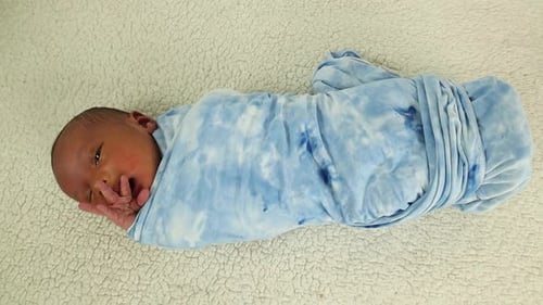 Swaddled Infant Lying on White Blanket