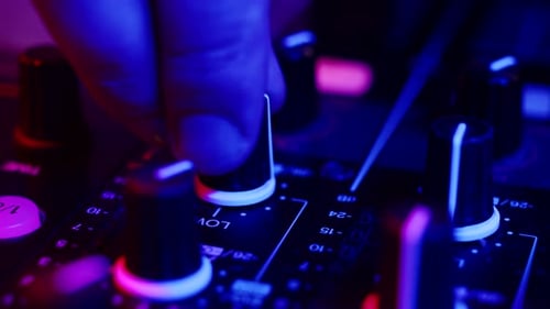 Hand Adjusts Knob on Sound Mixing Board