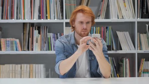 Man Using Smartphone, Browsing online at Work