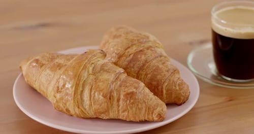 Crisp Croissants and Coffee on a Wooden Table