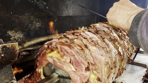 Juicy Meat Roasting on Vertical Spit Over Fire