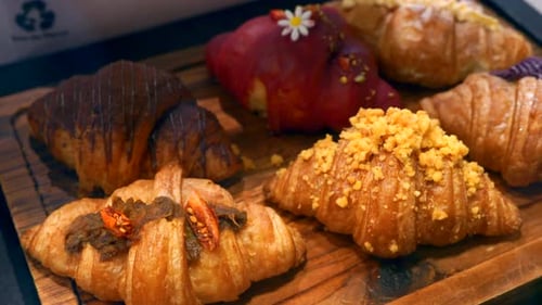 Variety of Delicious Croissants on Wooden Board