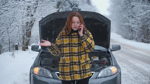 Woman on Phone Next to Broken Down Car