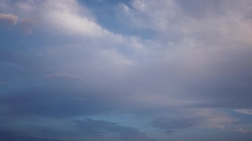 Clouds timelapse on blue sky at sunset