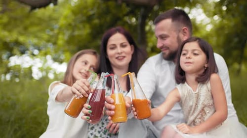 Happy Family Enjoying Picnic Outdoors