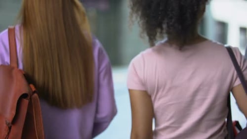 Back View of Multiethnic Students With Backpacks Walking Outdoors, University