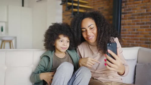 Child and Adult Taking Cheerful Selfie at Home