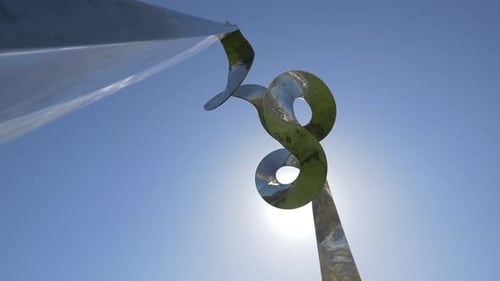Abstract Metallic Sculpture Against Blue Sky on Sunny Day