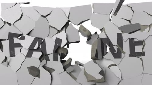 Breaking Concrete Wall with Painted FAMINE Word