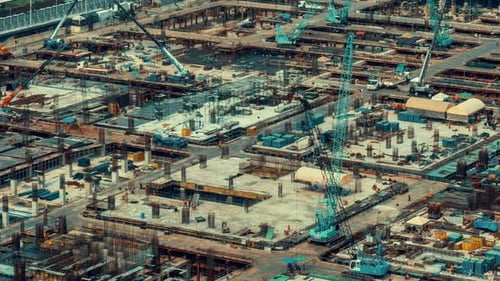 Time lapse of construction site with heavy construction machinery in metropolis