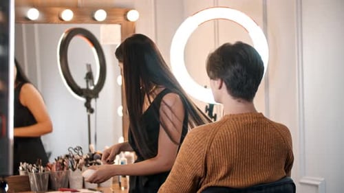 Makeup Artist Applying Cosmetics in Beauty Salon