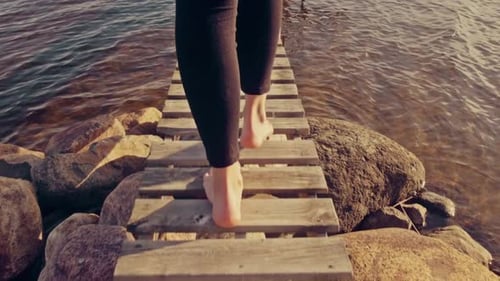 Woman Walking Barefoot on Jetty