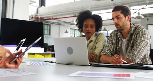 Team Working Together at Office Table on Laptop