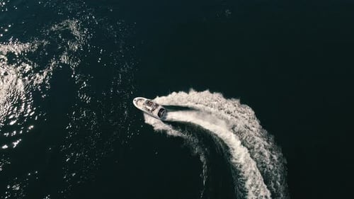 Drone Topview Of Speedboat Circle Turns With People Enjoying Summer Recreation