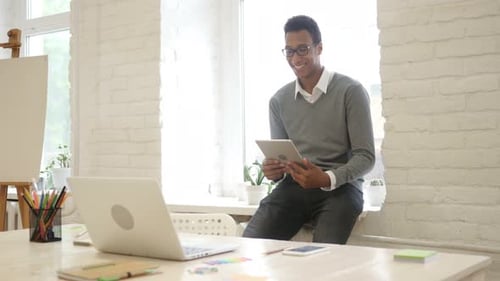 Man Using Tablet in Bright Indoor Studio