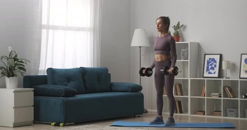 Woman Doing Bicep Curls with Dumbbells at Home