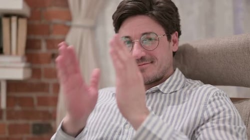 Man in Glasses Clapping Hands Indoors