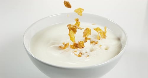 Corn Flakes Pouring Into Milk Bowl