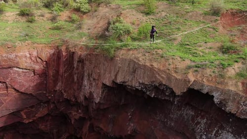 Person Highlining Across Canyon Cliff on Slackline