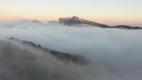 Mountain Peak Emerges From Cloudscape At Sunrise
