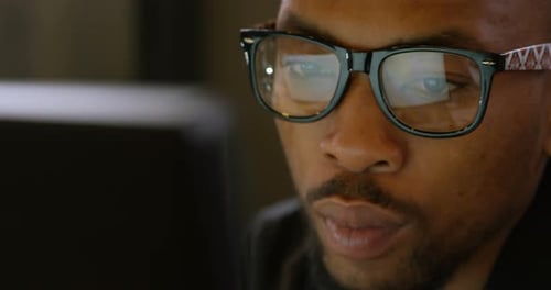 Male executive working on computer at desk in office 4k