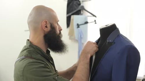Tailor measuring a suit jacket