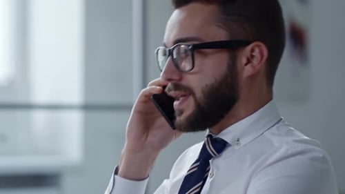 Stylish Young Adult Talking on Phone in Office