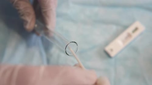 Medical Professional Using Swab in Test Tube